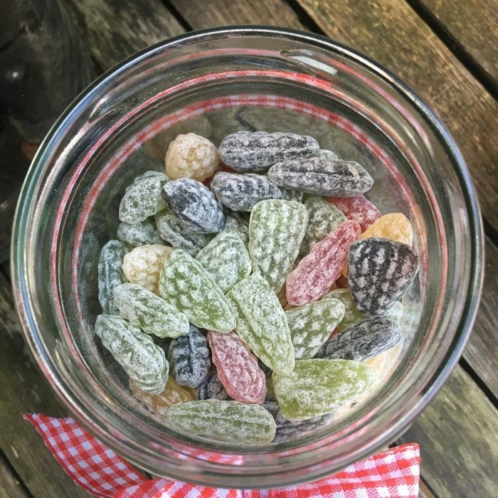 Traditional Vosges candies with essential oils in a glass jar