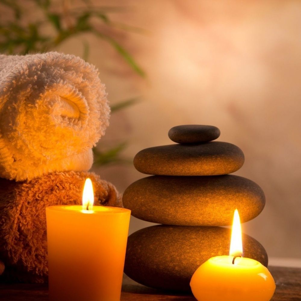 Wellness atmosphere at Les Bas Rupts hotel, candles, stones and towel for a relaxing spa-like setting