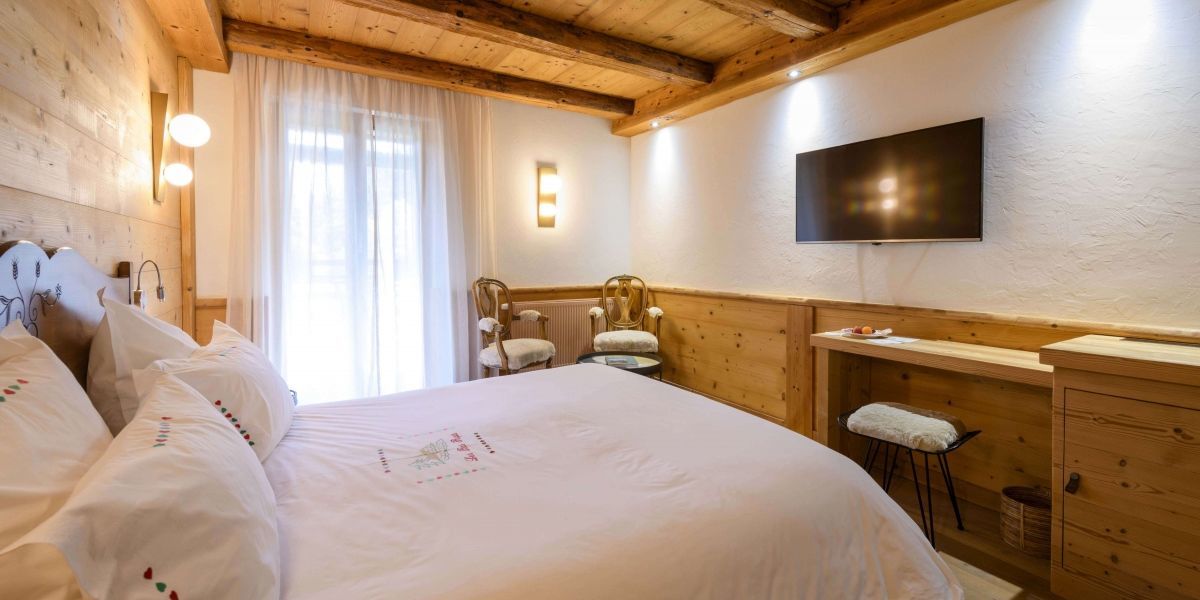 Confort room at Hotel Les Bas Rupts, cozy mountain-style with private terrace overlooking the mountains and forest