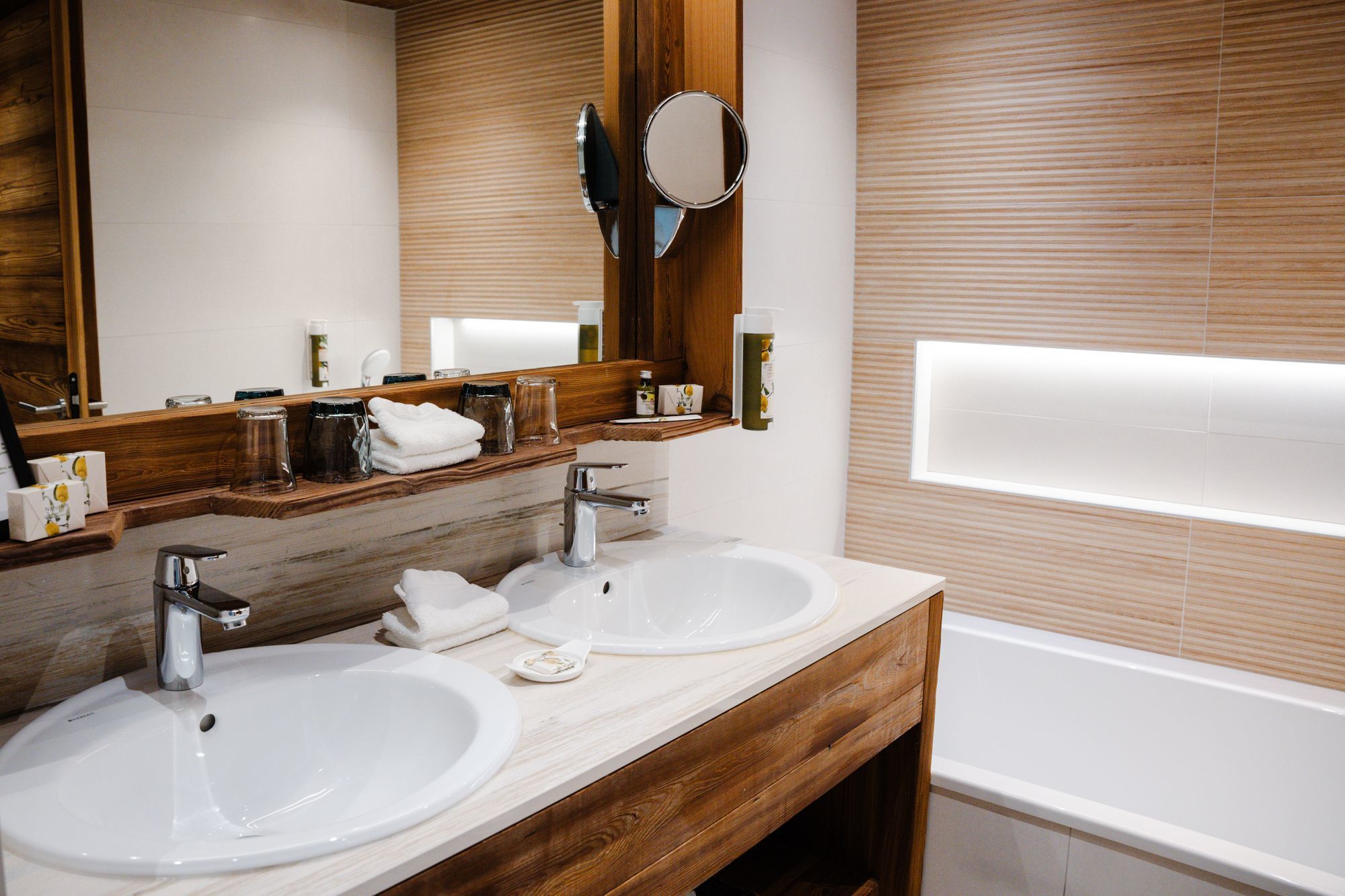 Suite Junior de l’hôtel Les Bas Rupts avec chambre, salon séparé, salle de bains moderne et terrasse offrant une vue sur la nature.