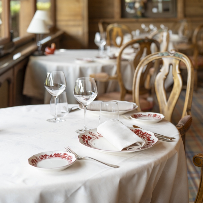 Elegantly set table in the cozy dining room of Les Bas Rupts restaurant for the lunch menu