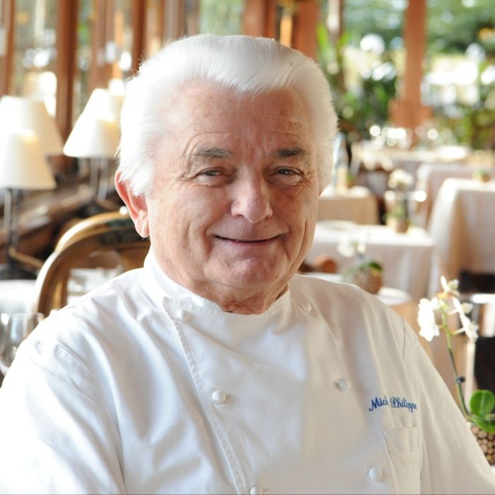Michel Philippe, iconic figure of Les Bas Rupts, in chef’s attire inside the gourmet restaurant dining room