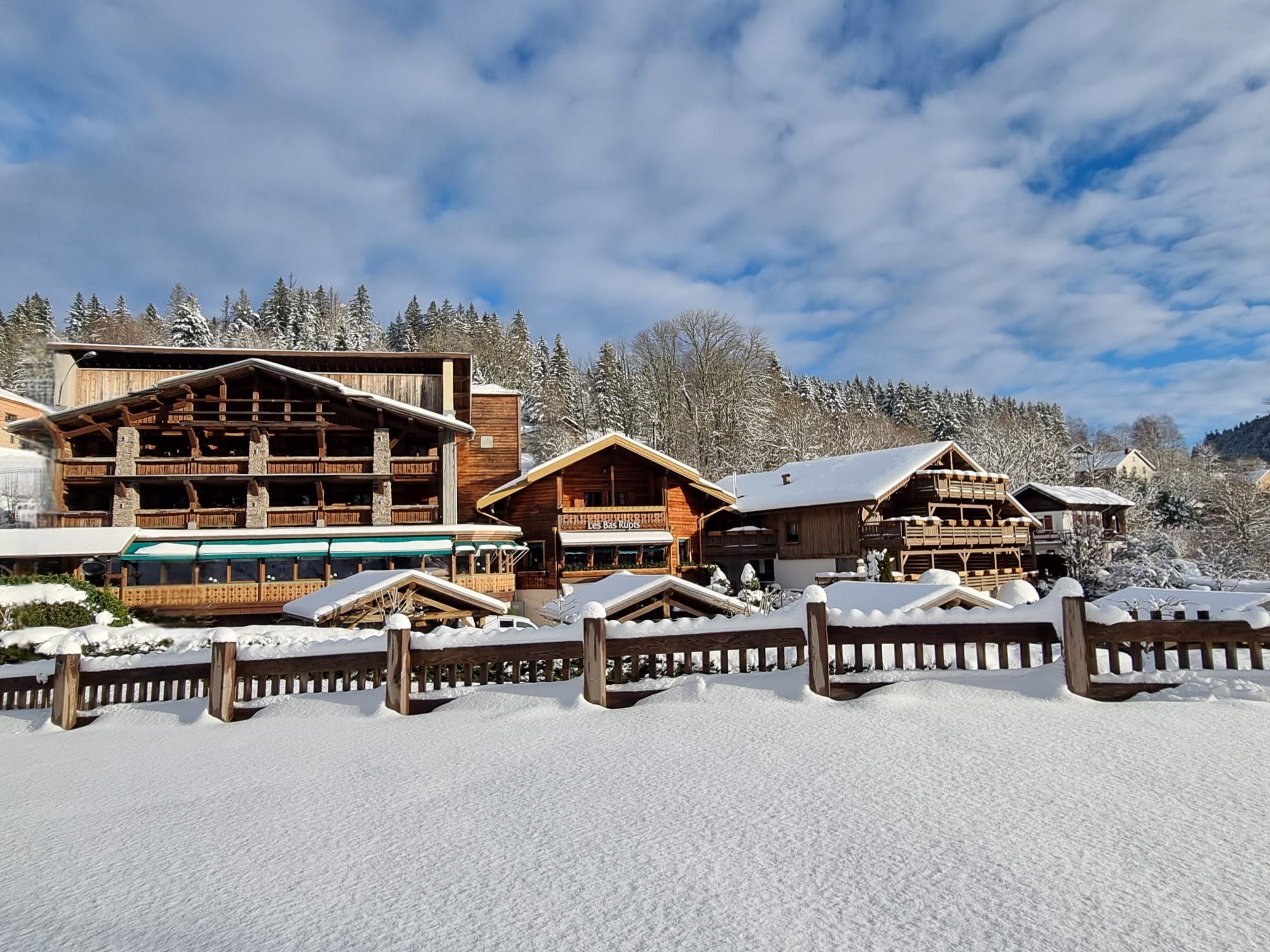 Overview of Les Bas Rupts hotel in Gérardmer: wooden chalets in a mountain setting, elegant rooms, fine dining restaurant, indoor pool, gastronomy and pristine nature.